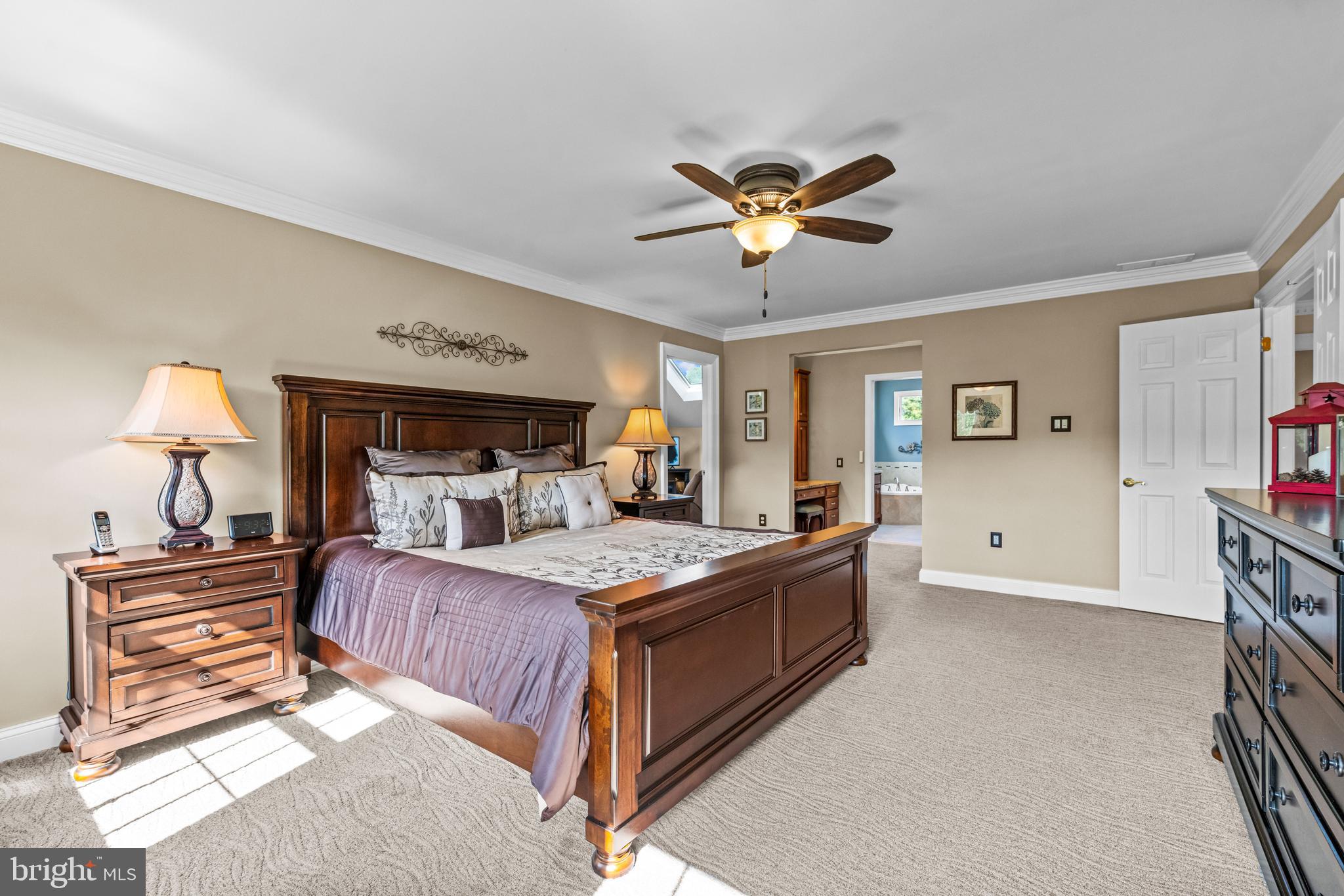 103 Fox Chase Court Southampton, NJ 08088 - Photo 43 of 98 a bedroom with a large bed and a chandelier