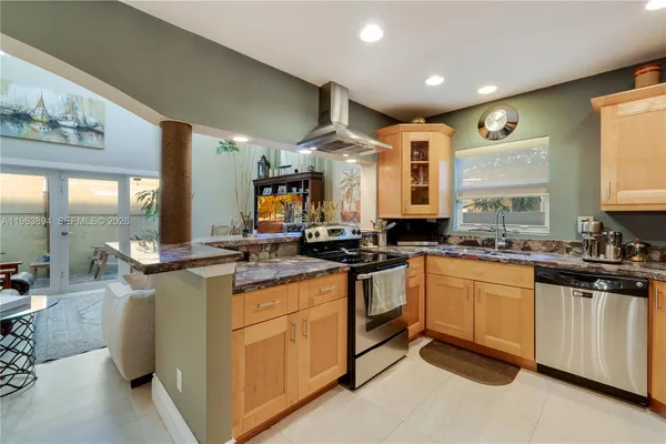 a kitchen with stainless steel appliances granite countertop a stove and cabinets