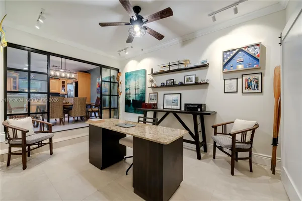 a view of a livingroom with furniture and a ceiling fan
