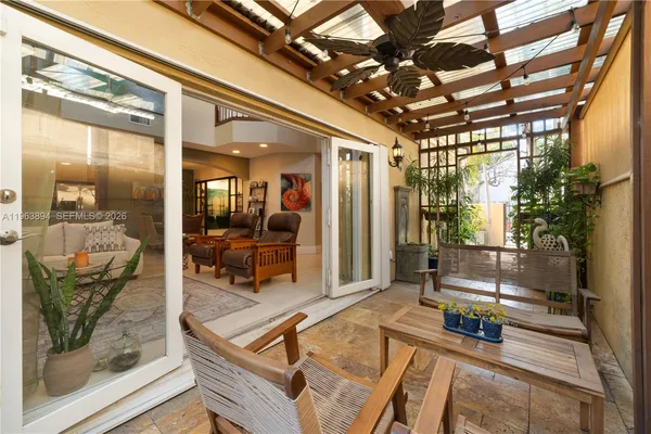 a room with lots of furniture and glass door