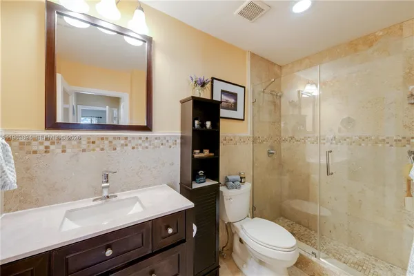 a bathroom with a sink toilet and a mirror