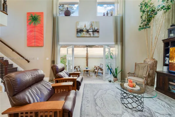 a living room with furniture and a potted plant