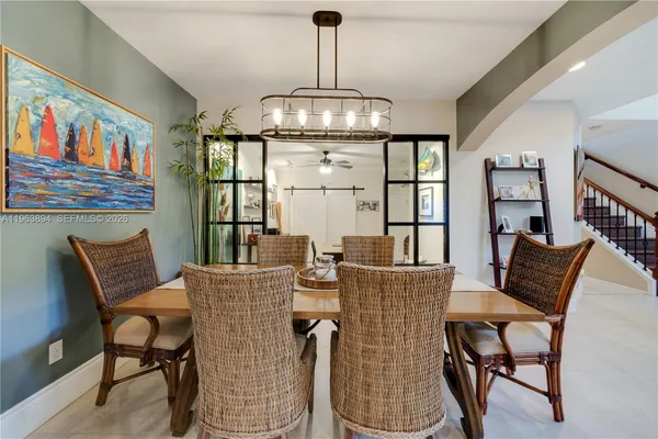 a view of a dining room with furniture large window and wooden floor