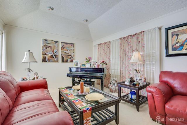 a living room with furniture and a chandelier