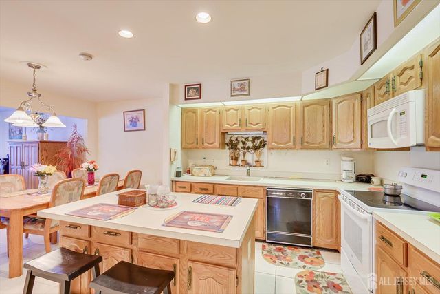 a kitchen with stainless steel appliances a sink and cabinets