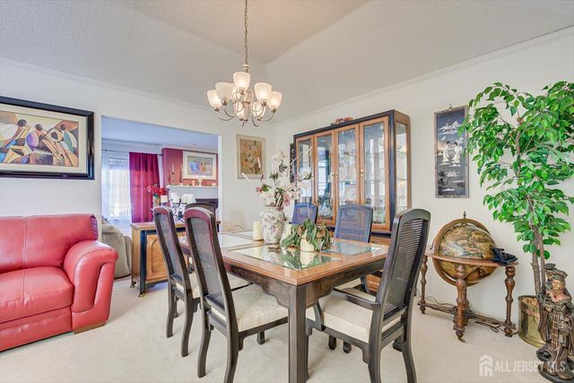 a living room with furniture a fireplace and a large window