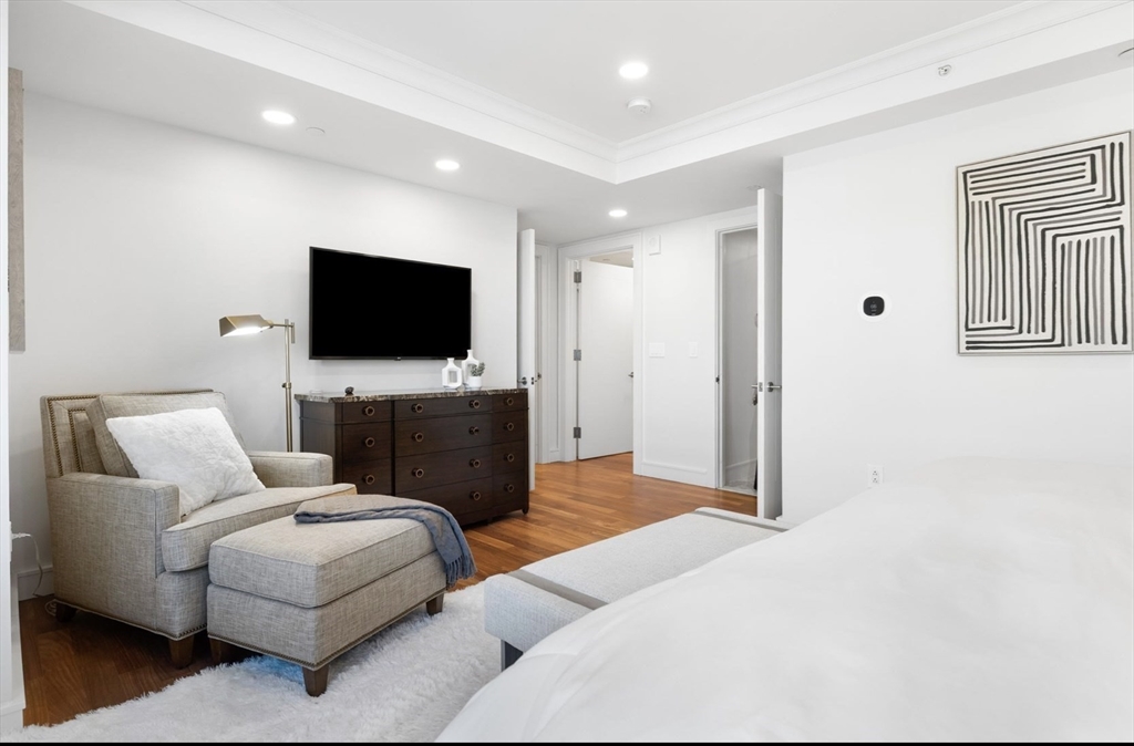 4 Battery Wharf, Unit PH 46 Boston, MA 02109 - Photo 16 of 39 a living room with furniture and a flat screen tv