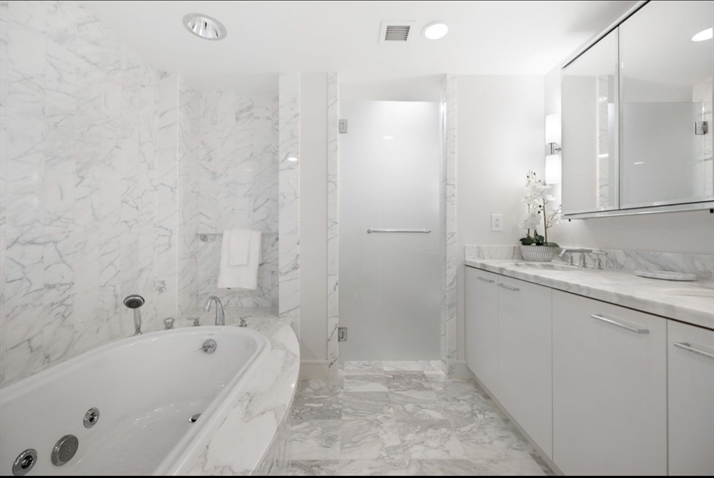 4 Battery Wharf, Unit PH 46 Boston, MA 02109 - Photo 17 of 39 a bathroom with a bathtub and a sink