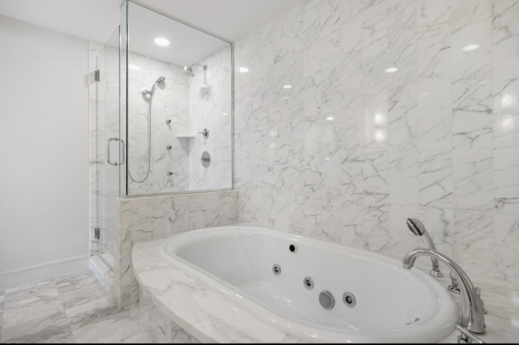 4 Battery Wharf, Unit PH 46 Boston, MA 02109 - Photo 18 of 39 a bathroom with a bathtub and shower