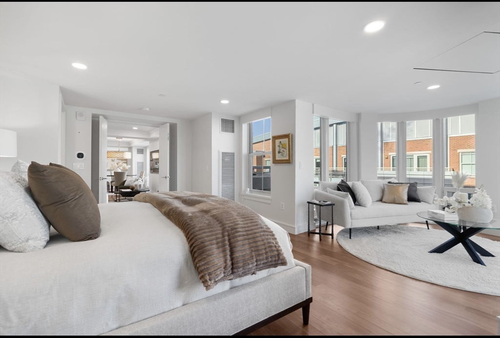 4 Battery Wharf, Unit PH 46 Boston, MA 02109 - Photo 21 of 39 a spacious bedroom with a bed a couch and large windows