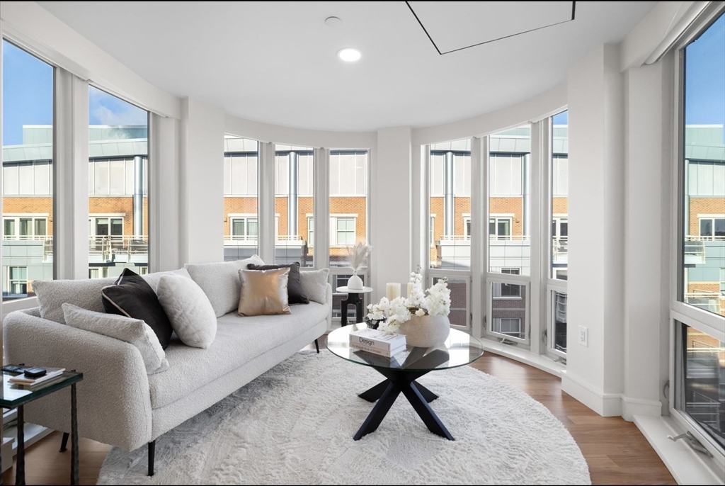 4 Battery Wharf, Unit PH 46 Boston, MA 02109 - Photo 22 of 39 a living room with furniture and a floor to ceiling window