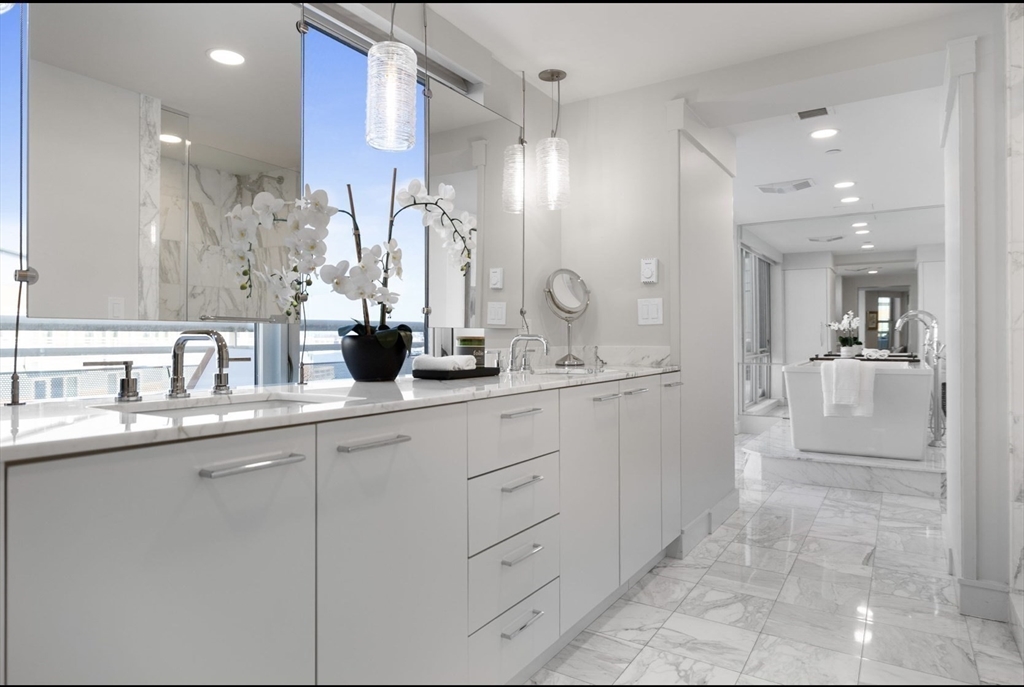 4 Battery Wharf, Unit PH 46 Boston, MA 02109 - Photo 27 of 39 a bathroom with a double vanity sink mirror and