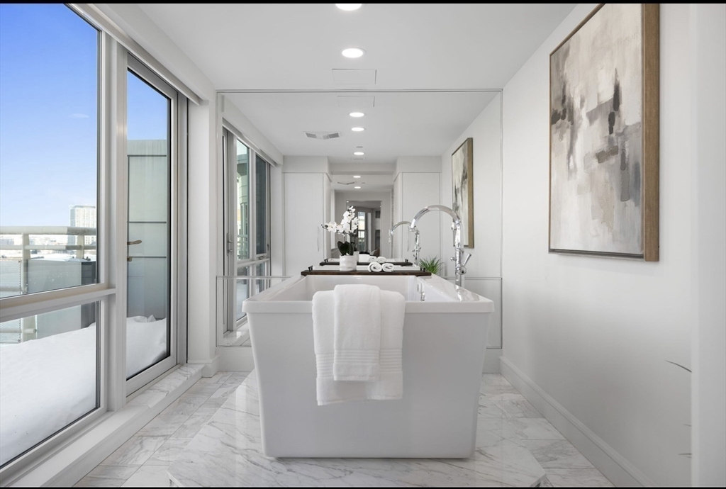 4 Battery Wharf, Unit PH 46 Boston, MA 02109 - Photo 29 of 39 a view of kitchen with stainless steel appliances kitchen island granite countertop a refrigerator and a sink
