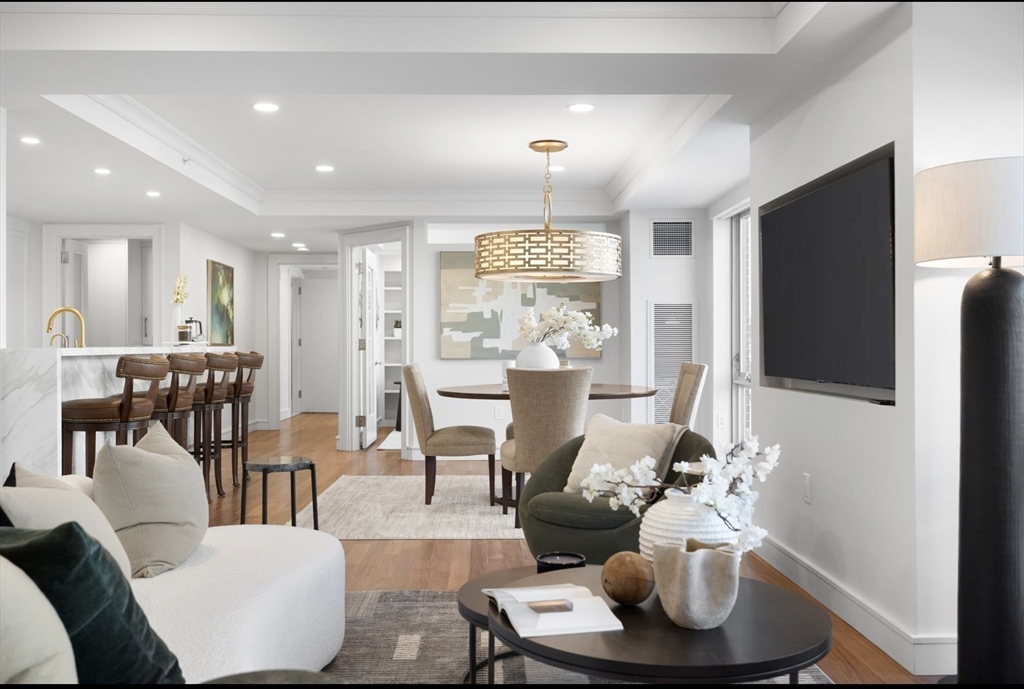 4 Battery Wharf, Unit PH 46 Boston, MA 02109 - Photo 3 of 39 a living room with furniture and a flat screen tv