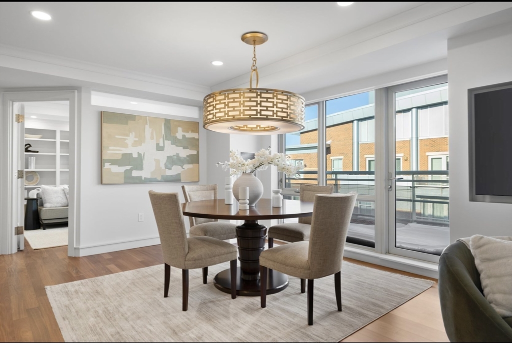 4 Battery Wharf, Unit PH 46 Boston, MA 02109 - Photo 5 of 39 a dining room with furniture a chandelier and wooden floor