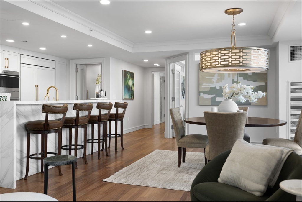 4 Battery Wharf, Unit PH 46 Boston, MA 02109 - Photo 8 of 39 a view of a dining room with furniture window and wooden floor