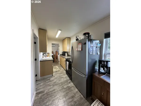 a view of a kitchen from the hallway
