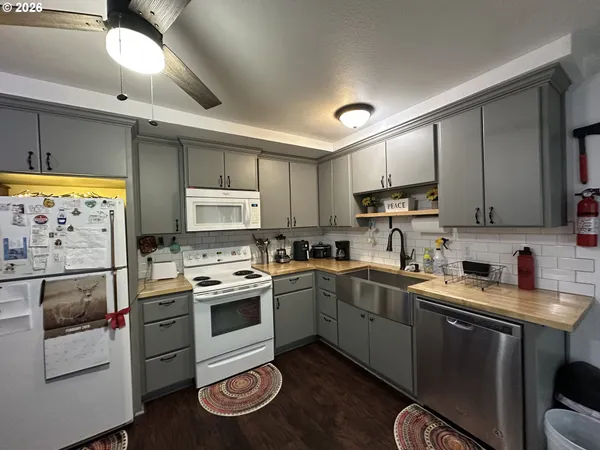 a kitchen with stainless steel appliances a stove sink microwave and cabinets