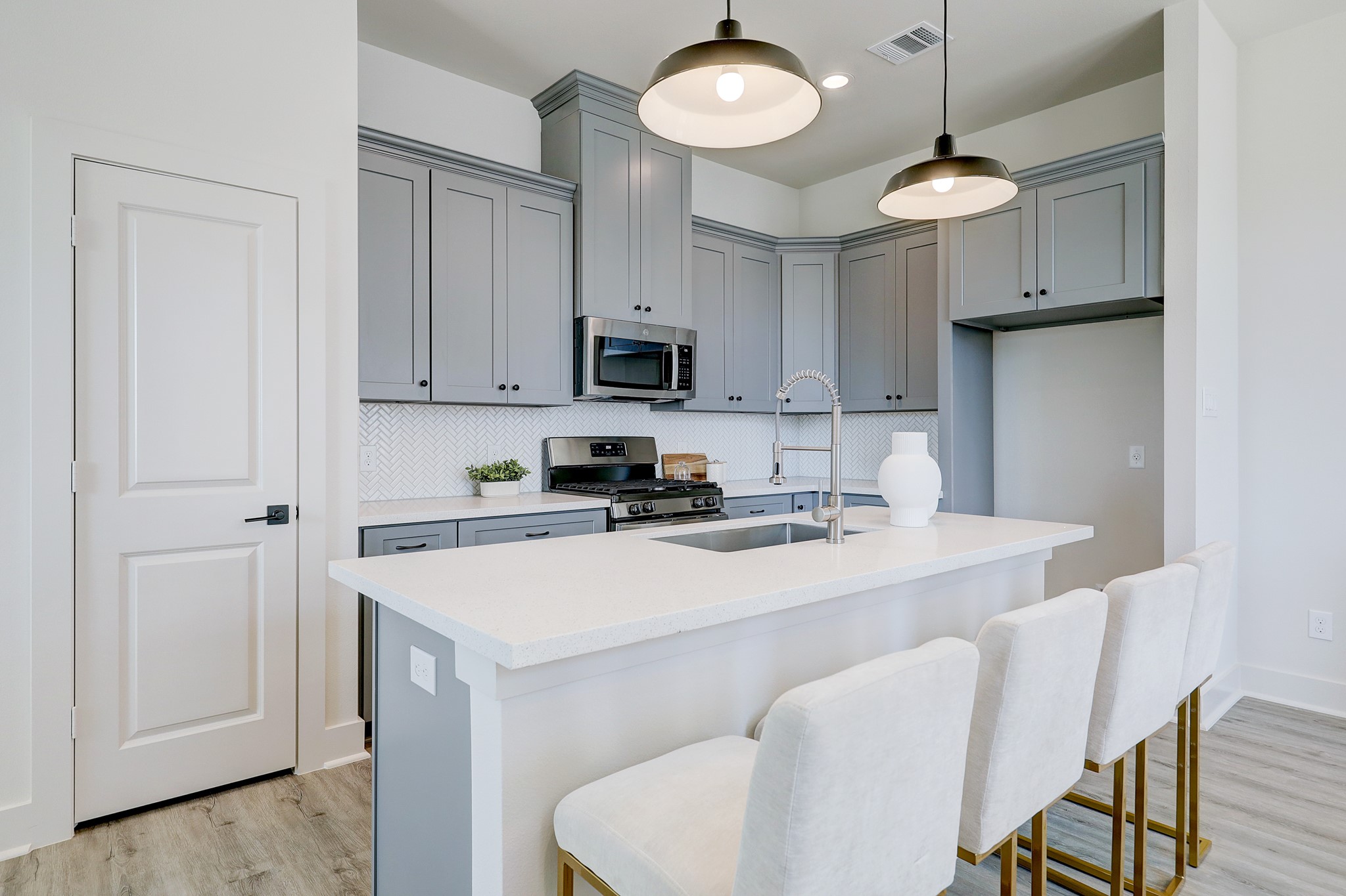 5242 Texas Street Houston, TX 77011 - Photo 14 of 27 a kitchen with stainless steel appliances a stove a sink a refrigerator a dining table and chairs