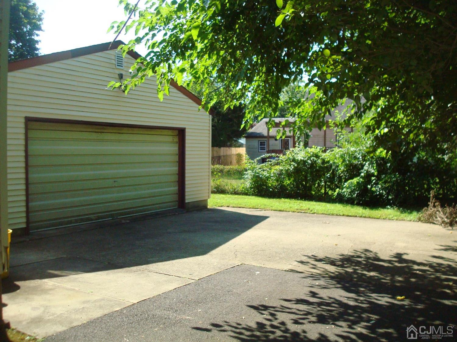 7 James Road East Brunswick, NJ 08816 - Photo 20 of 21 a front view of a house with a yard and garage