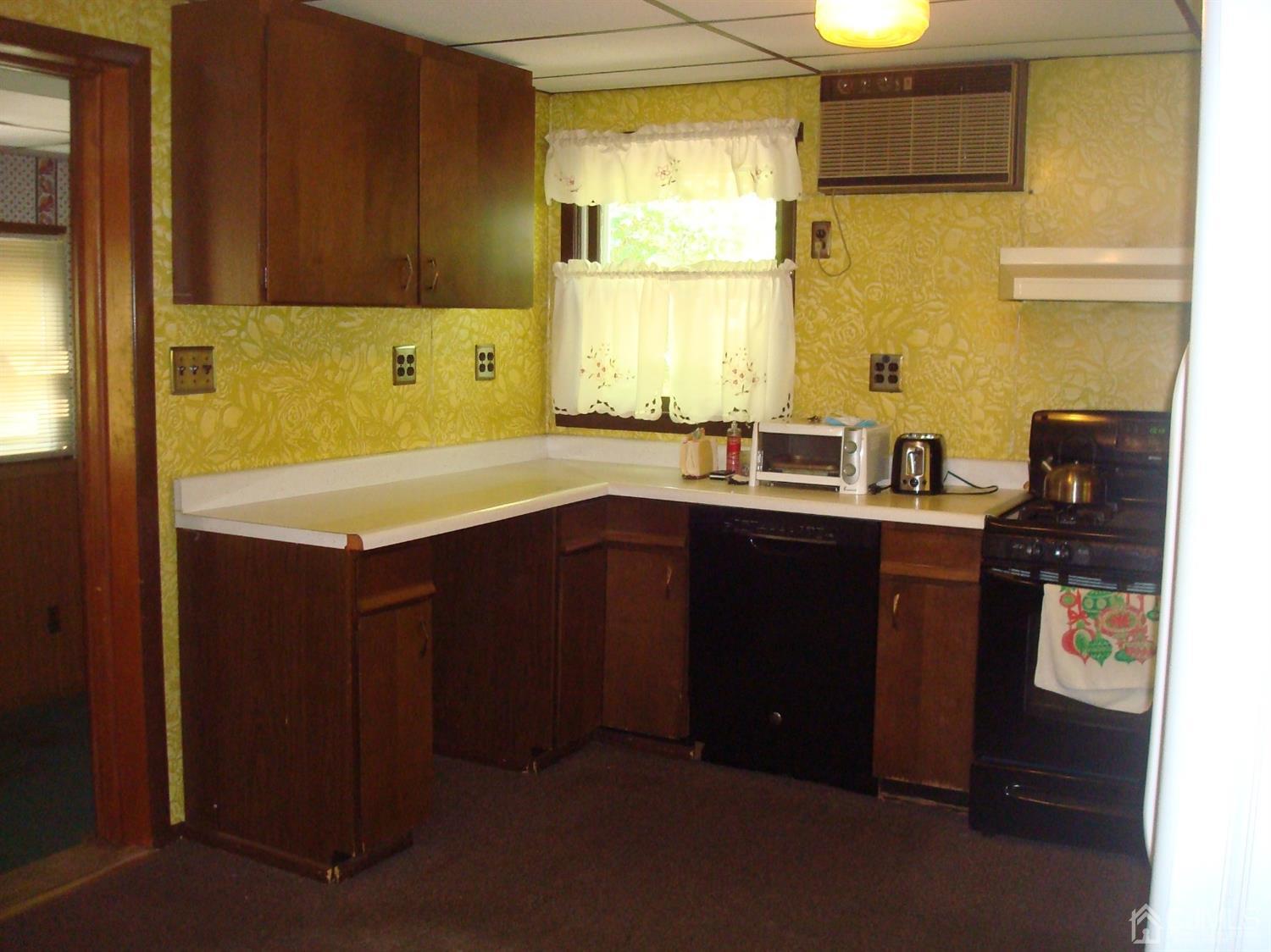 7 James Road East Brunswick, NJ 08816 - Photo 3 of 21 a kitchen with a sink a stove and wooden cabinets