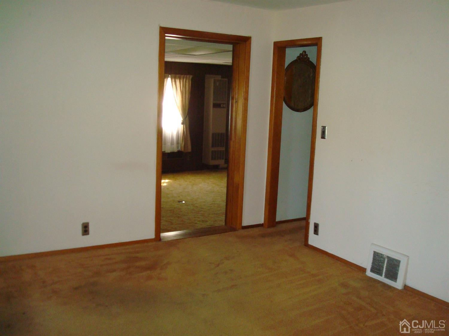 7 James Road East Brunswick, NJ 08816 - Photo 7 of 21 a view of an empty room with wooden door