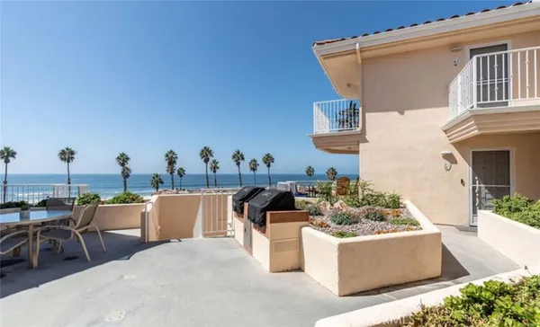a view of a patio with table and chairs