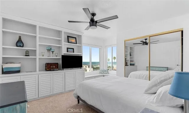 a bedroom with a bed a window and closet