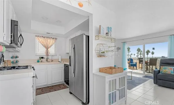 a kitchen with refrigerator and cabinets