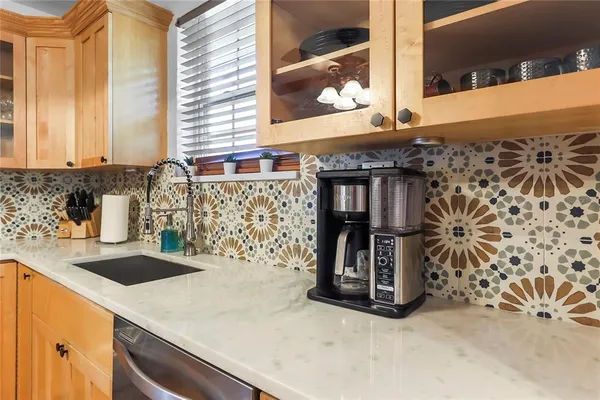 a kitchen with a sink and a large mirror