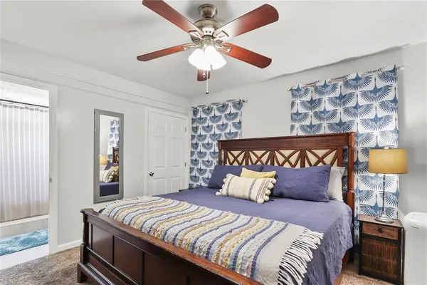 a bedroom with a bed and a lamp
