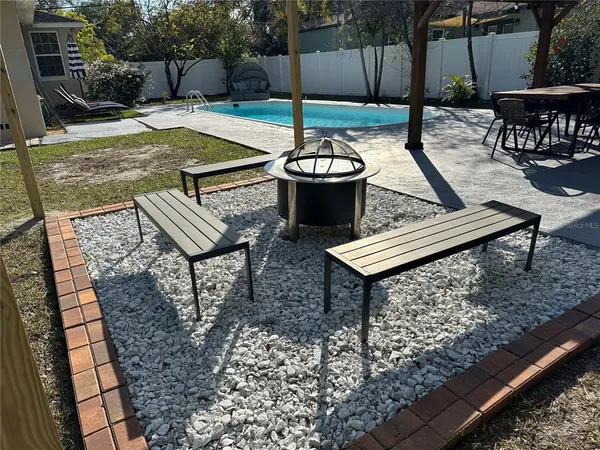 a view of a backyard with sitting area