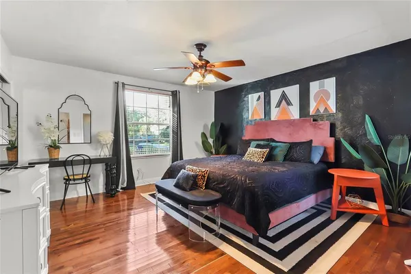 a bedroom with a bed and wooden floor