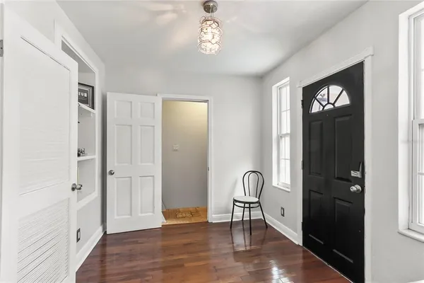 a view of an entryway with wooden floor