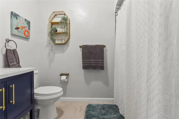 a bathroom with a toilet a sink and mirror