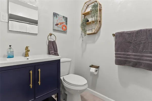 a bathroom with a toilet a sink and mirror