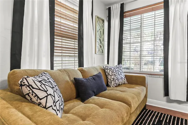 a bedroom with furniture and a large window