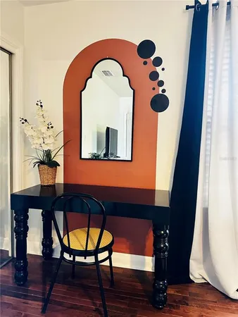 a view of a balcony with furniture and wooden floor