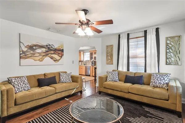 a living room with furniture a rug and a window