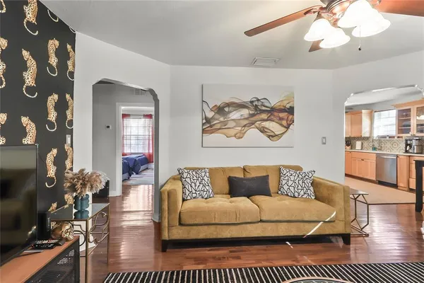a living room with furniture a rug and a chandelier