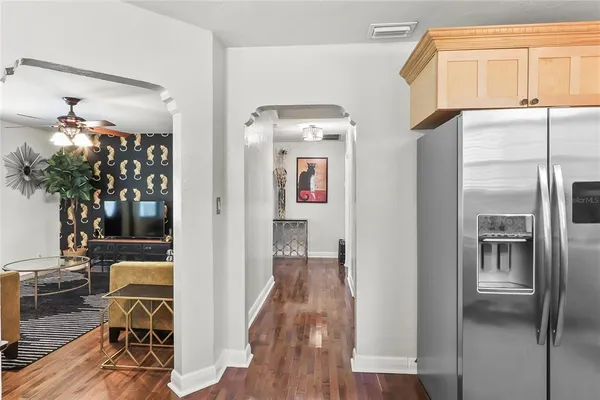 a view of a hallway view with wooden floor and staircase
