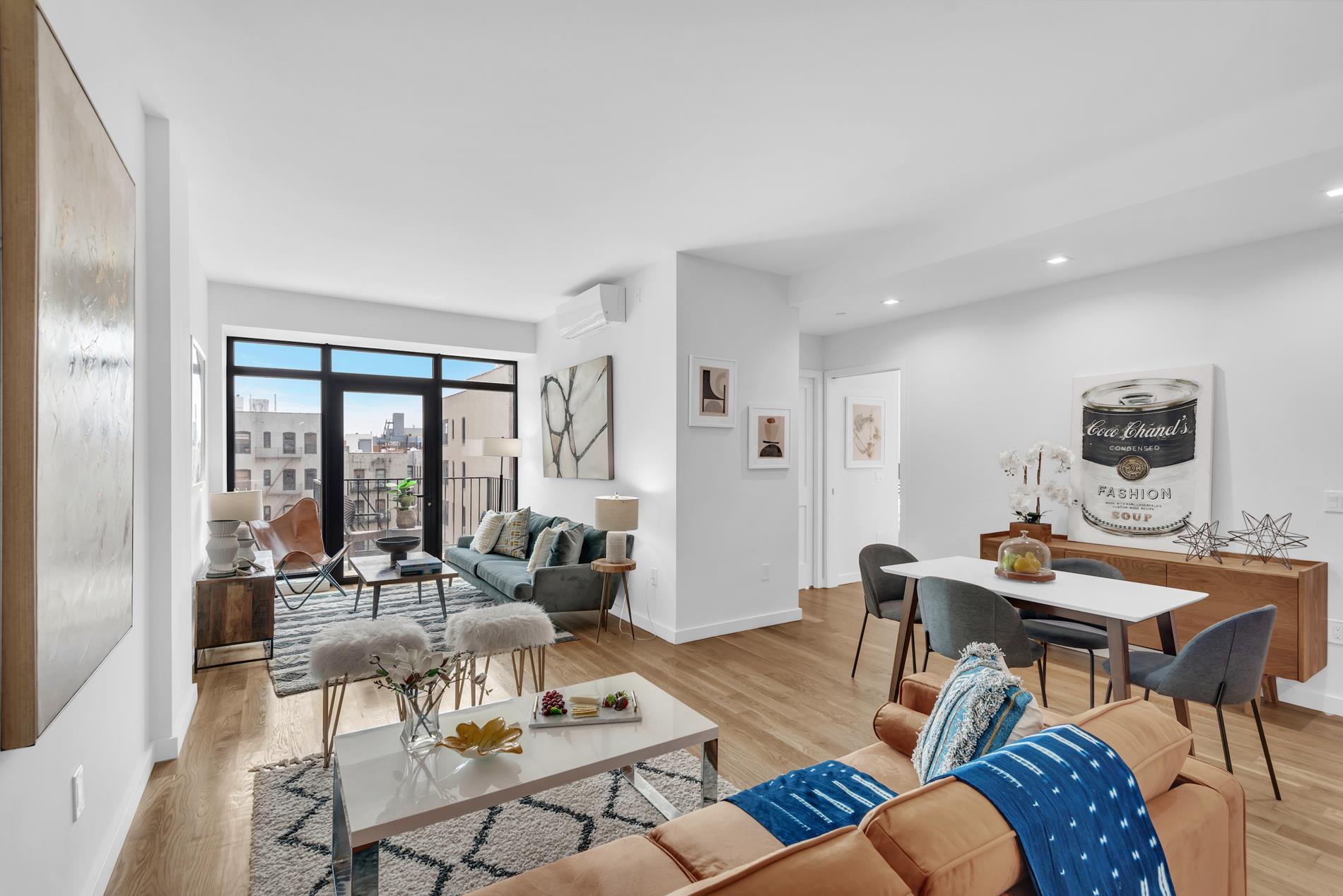 30-38 29th Street, Unit 6C Queens, NY 11102 - Photo 1 of 11 a living room with furniture and large windows
