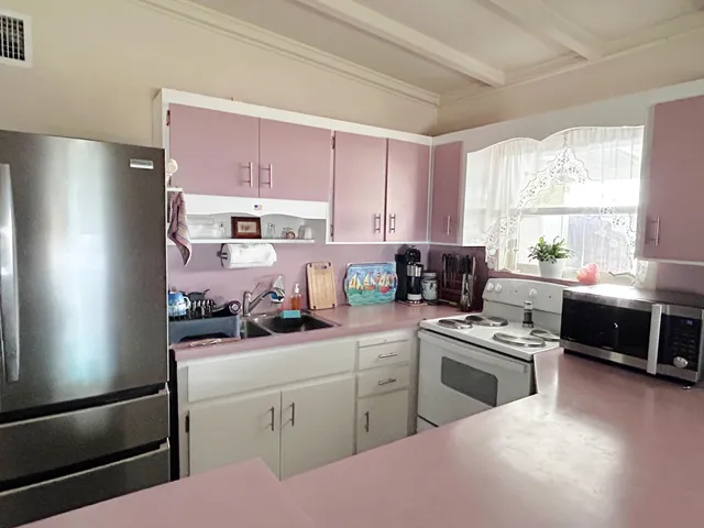 a kitchen with a sink a stove and cabinets