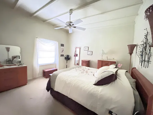 a bedroom with a bed and window