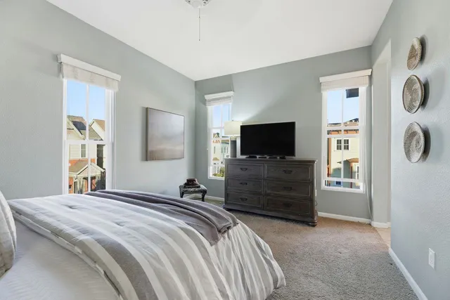 a bedroom with a bed and a flat screen tv