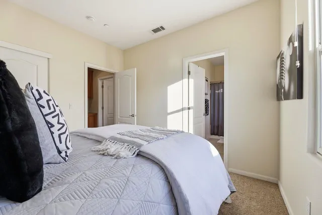 a bed room with a bed and a large mirror