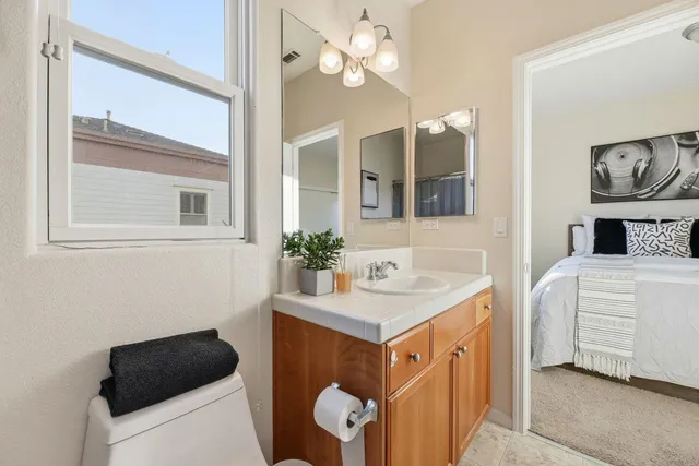 a bathroom with a sink a light fixture and a mirror