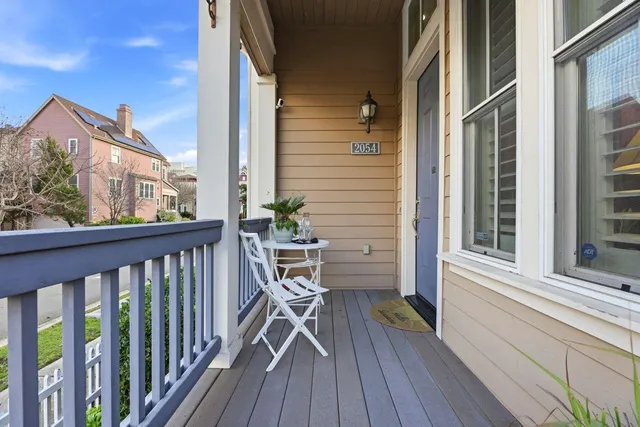 a view of a balcony with chairs and wooden floor