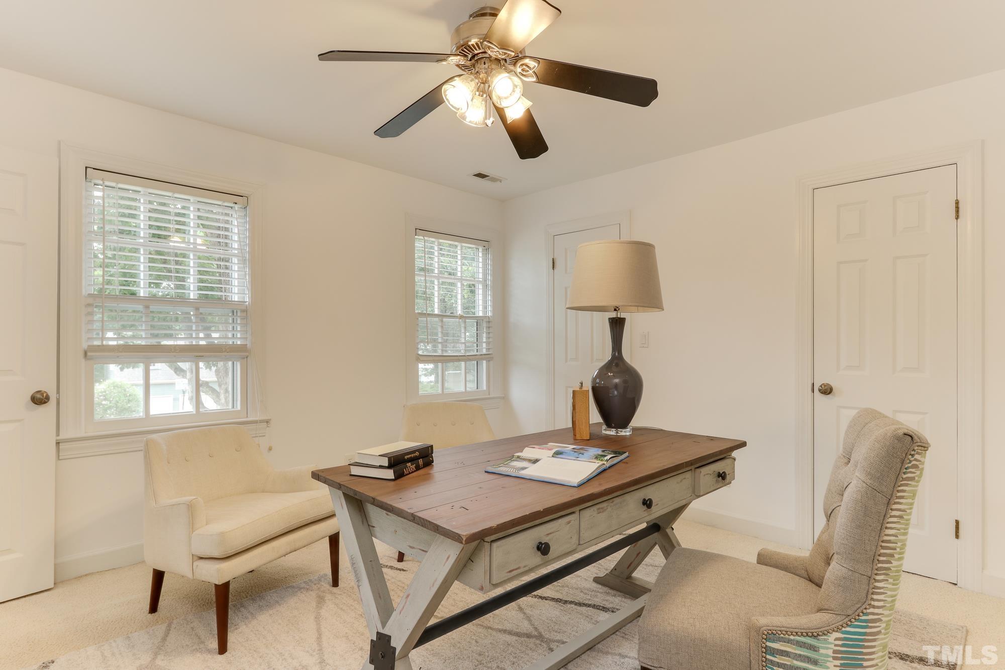 8913 Lindenshire Road Raleigh, NC 27615 - Photo 19 of 27 a living room with a table chairs and a window