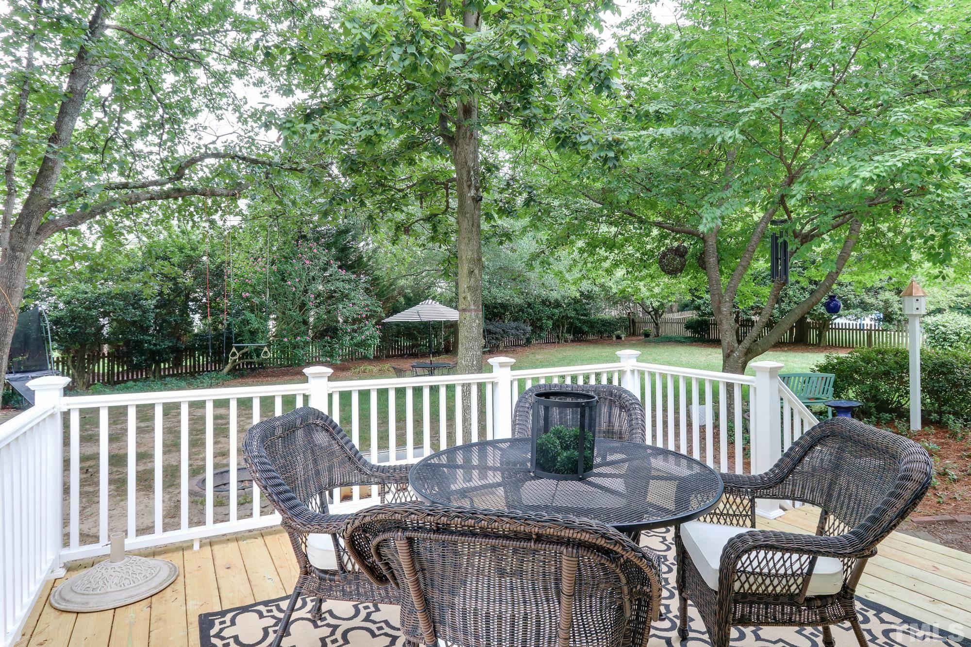 8913 Lindenshire Road Raleigh, NC 27615 - Photo 23 of 27 a view of a chair and table on the deck